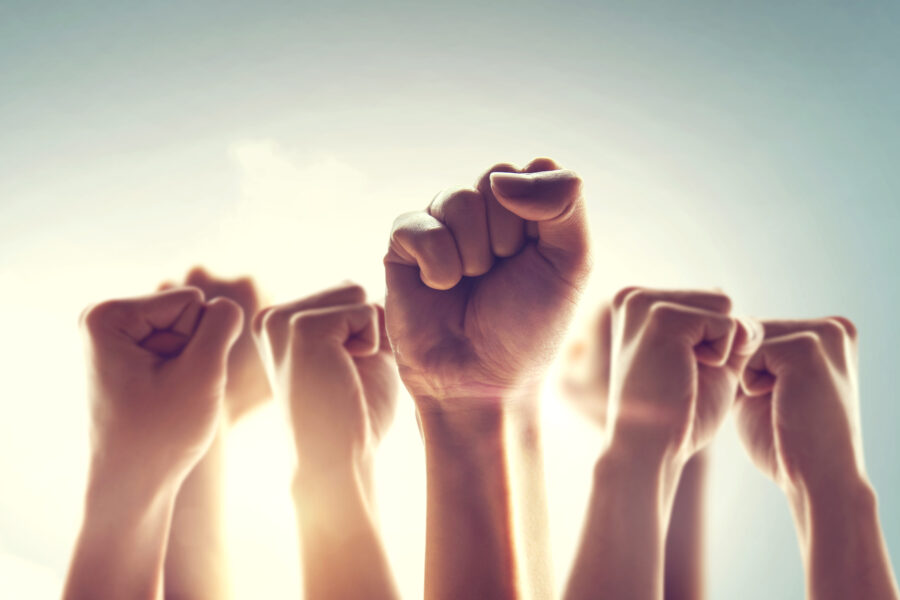 Peoples raised fist air fighting and sunlight effect, Competitio